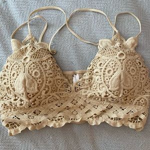 Cream colored, strappy lace bralette